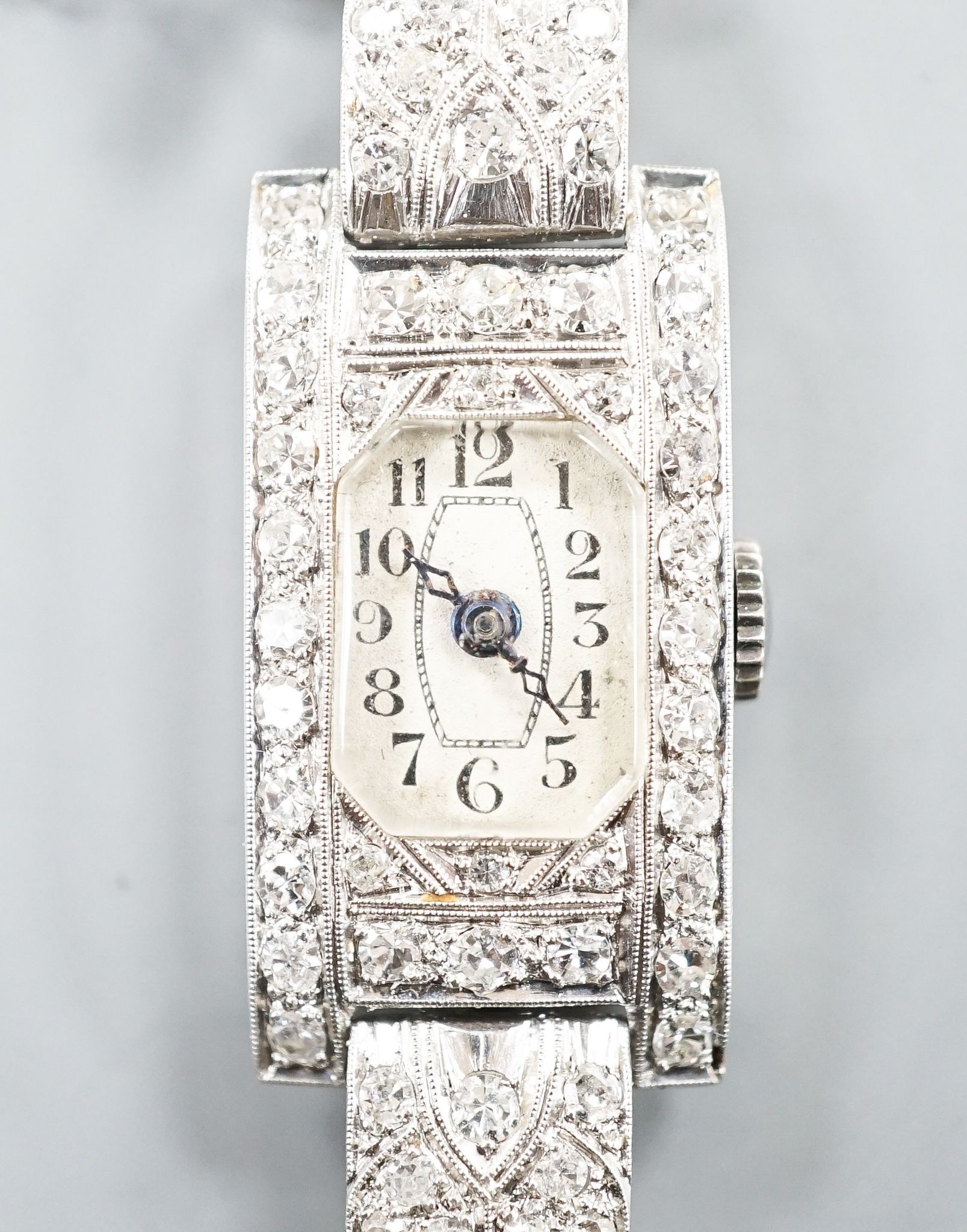 A lady's white metal (stamped platinum) and diamond set cocktail watch, the bracelet with diamond set shoulders, approx. 16cm, gross weight 23.8 grams.